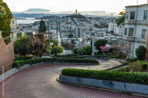 Crooked Lombard street at  dawn. San Francisco is in early morning light.
