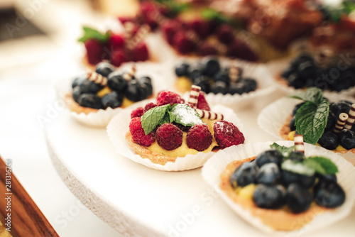 Raspberry custard pastry tart on a display stand