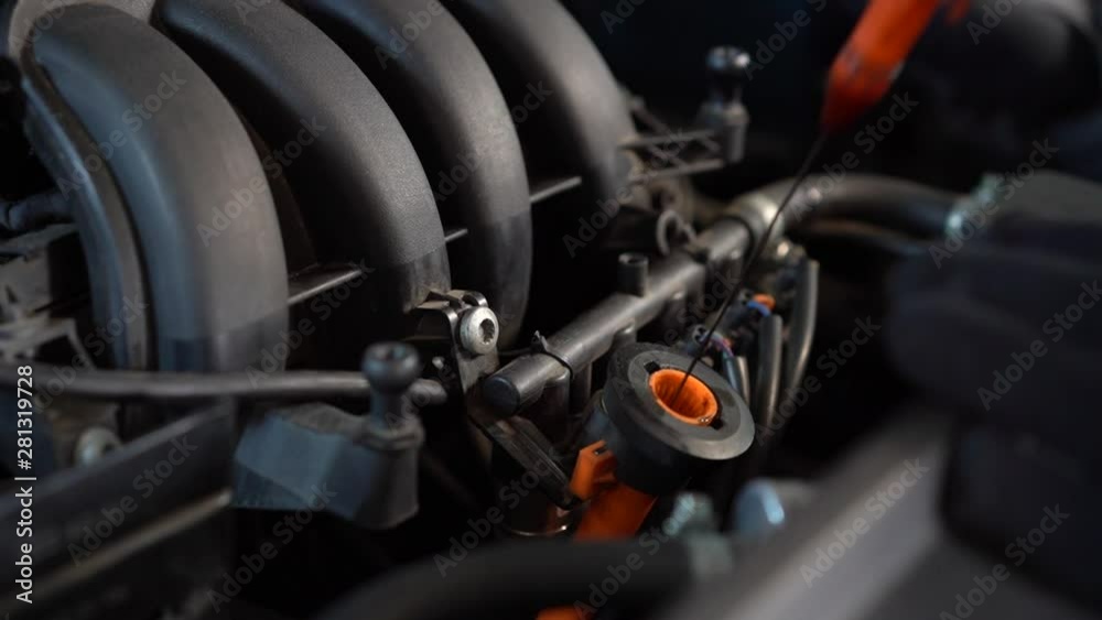 Checking oil level in a car engine close up Checking oil level in a car engine close up