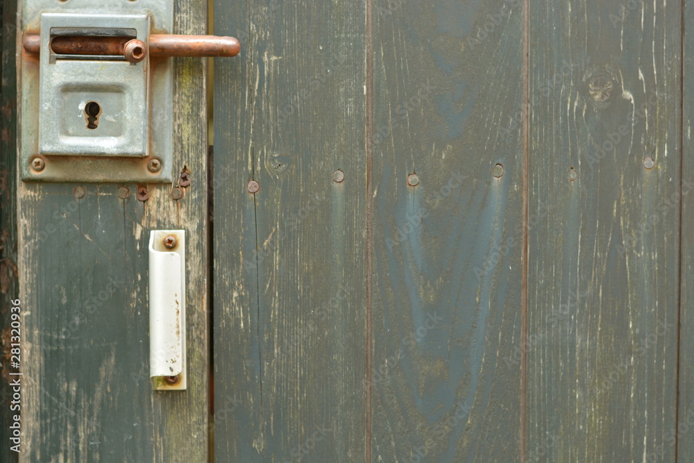 old green wooden door with lock on it old green wooden door with lock on it