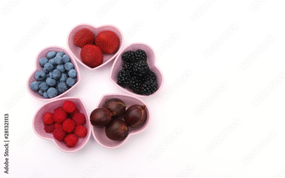 variety of berries in heart shaped bowls variety of berries in heart shaped bowls