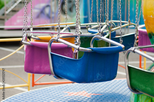 Fotografie closeup of carrousel chairs in attraction park