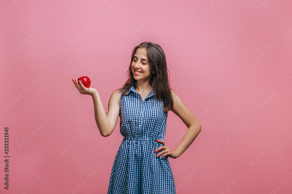 Girl holding red Apple on pink background Girl holding red Apple on pink background