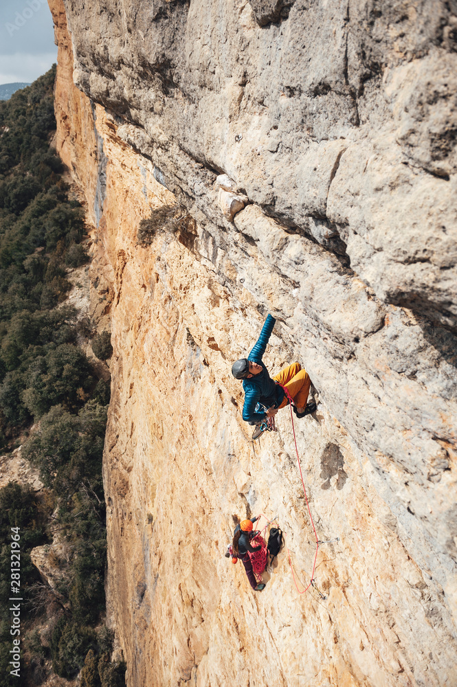 Climber man leading a multipitches route in Vilanova de Meia, Spain Climber man leading a multipitches route in Vilanova de Meia, Spain