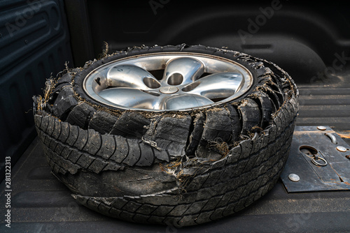 Blown tire in the bed of a pick up truck.