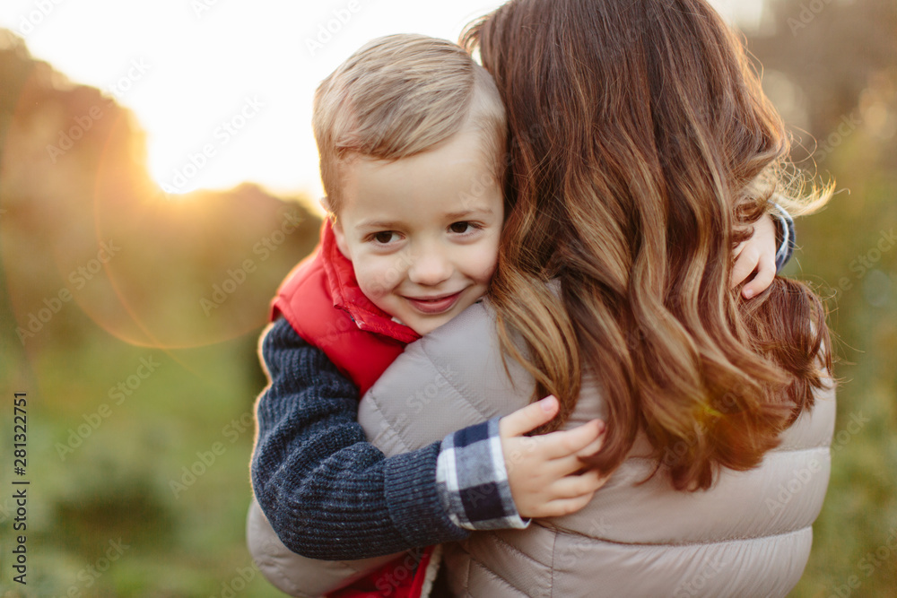 Portrait of a young boy being held by his mother Portrait of a young boy being held by his mother