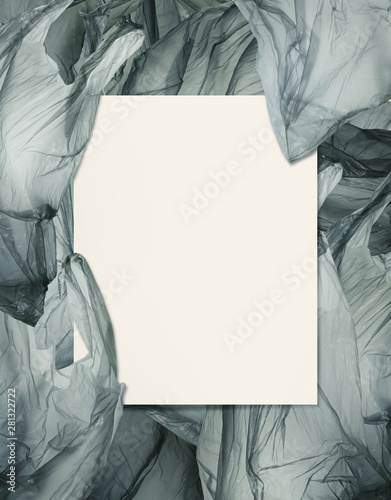 a card blank on pile of plastic bags.Environmentalism and plastic awareness concept background.