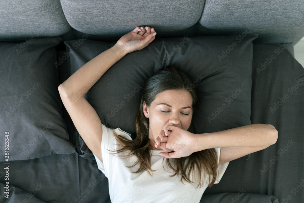 Young adult woman sleeping on bed in morning Young adult woman sleeping on bed in morning