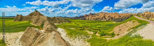 Panorama of formations with sunny skies at Badlands National Park. photo