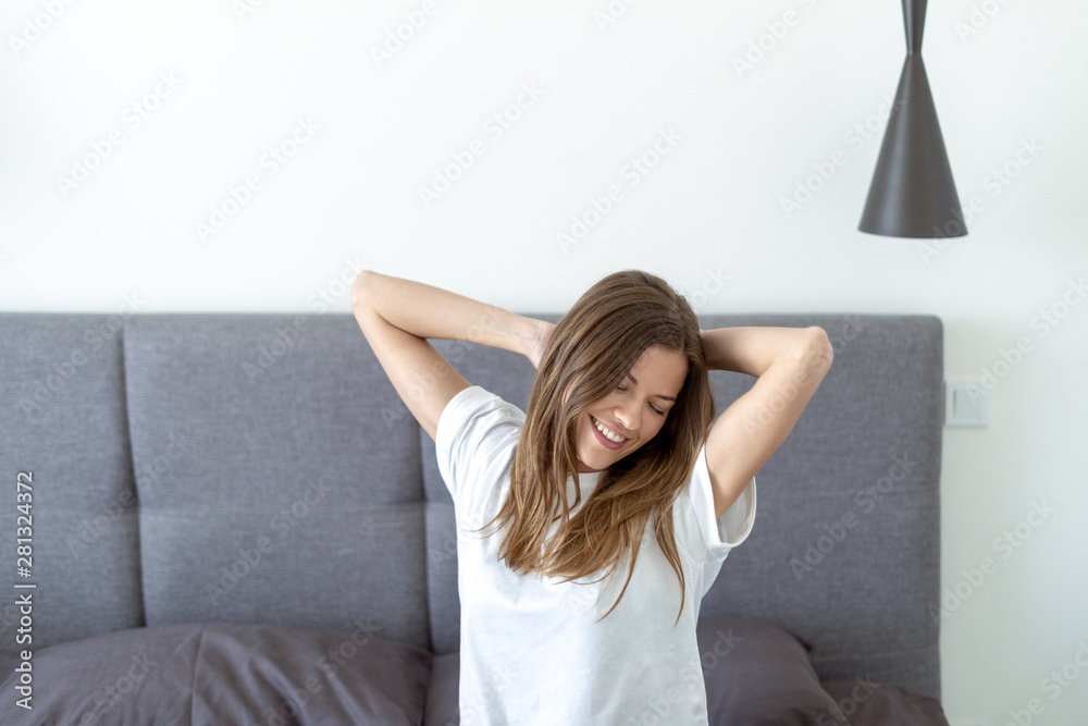 Young adult woman awaiking on bed in morning Young adult woman awaiking on bed in morning