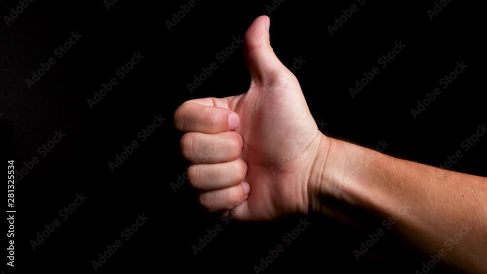Thumbs up like hand symbol of a male white hand on a plain background, close up Thumbs up like hand symbol of a male white hand on a plain background, close up