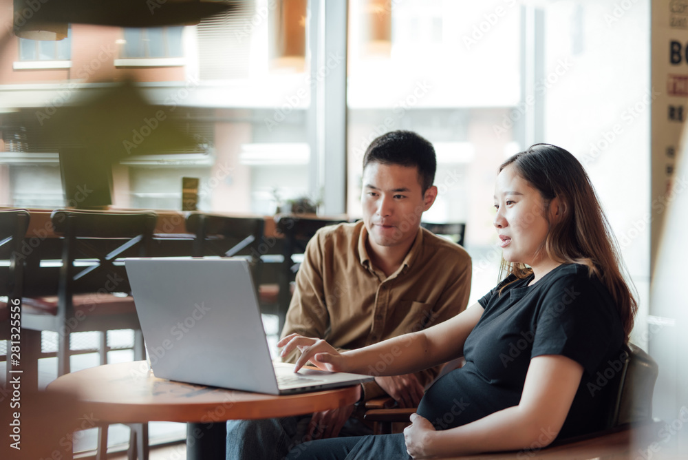 Pregnant woman and a colleague taking in cafe