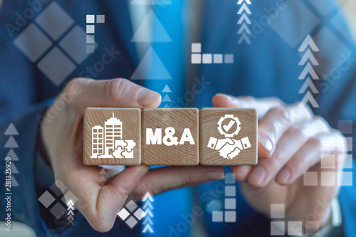 Merger and Acquisition Business Corporate Cooperation Company concept. M&Q partnership concept on wooden dices in businessman's hands. photo