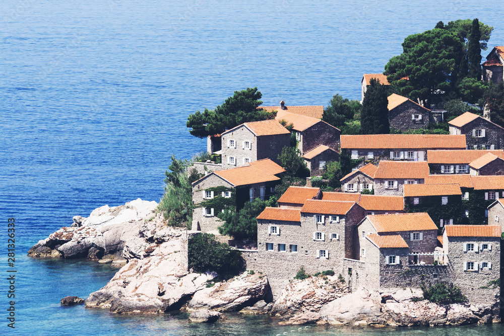 Sveti Stefan island in Budva in a beautiful summer day, Montenegro. Adriatic sea, Montenegro, Europe. Beautiful world of Mediterranean countries. Traveling concept background.