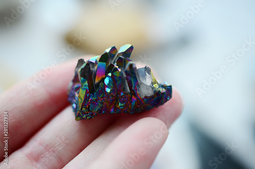 Titanium Flame Aura Quartz being held in woman's hand. Rainbow Titanium plated quartz Crystal points, Rainbow Flame Aura. Witchy crystals for a healing alter, reiki energy healing. 