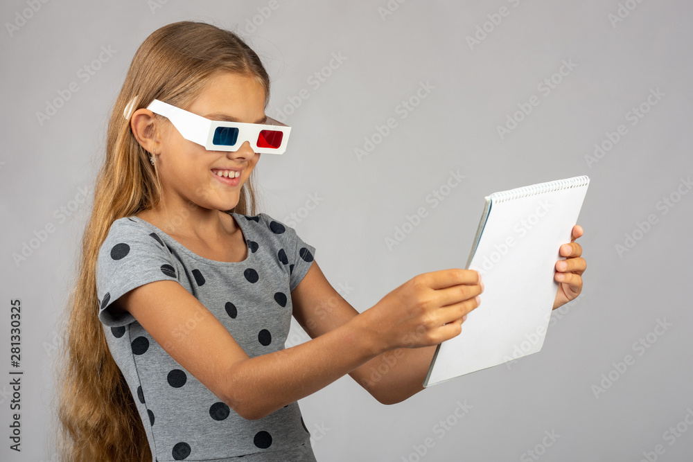 The girl is looking at the colored 3D glasses made using the anaglyph technology of 3D glasses