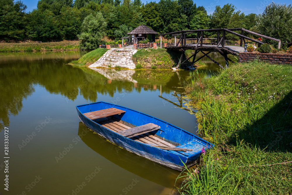 Old blue vintage wooden boat in a lake