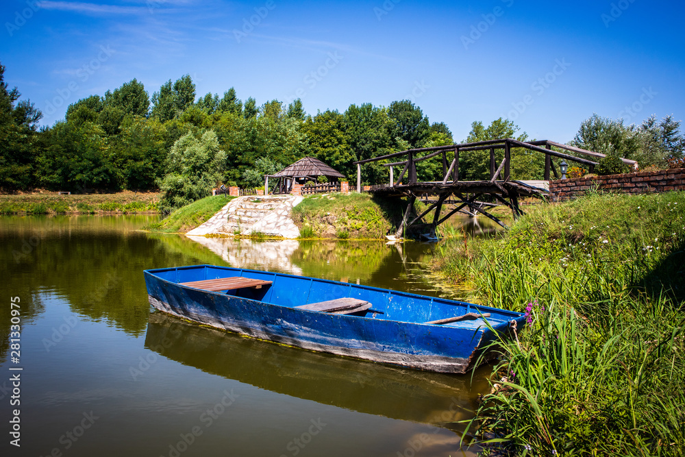 Obraz premium Old blue vintage wooden boat in a lake