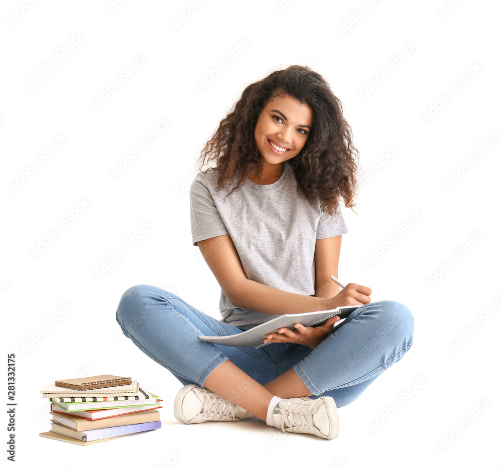 Portrait of cute African-American student on white background