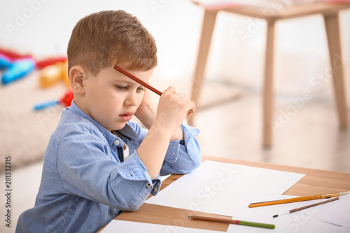 Cute little boy drawing at ...