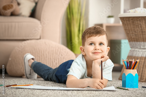 Cute little boy drawing at ...