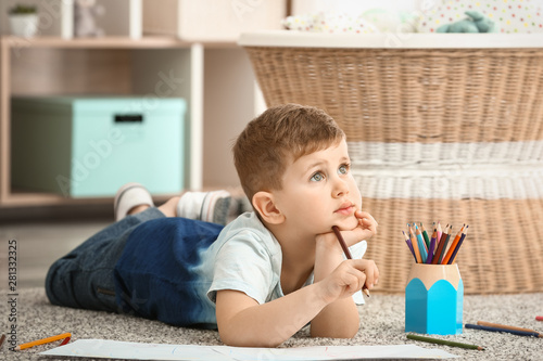 Cute little boy drawing at ...