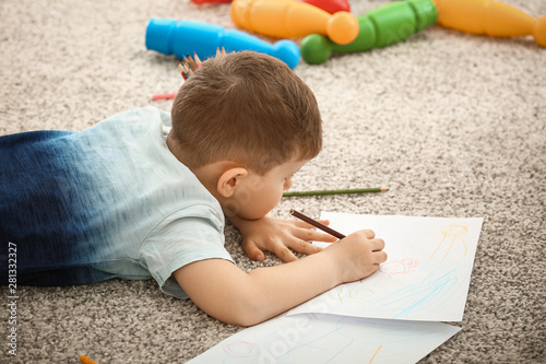Cute little boy drawing at ...