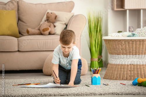 Cute little boy drawing at ...