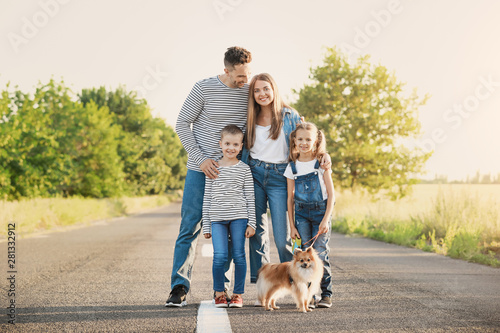 Happy family with dog on road