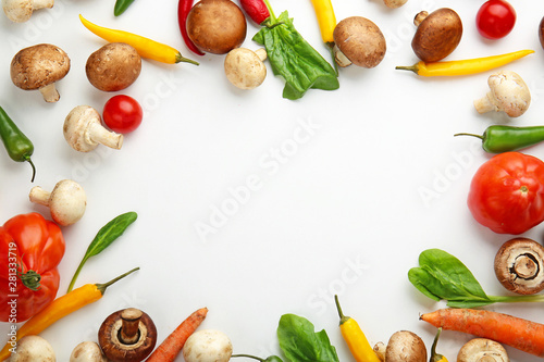 Frame made of different fresh vegetables on white background