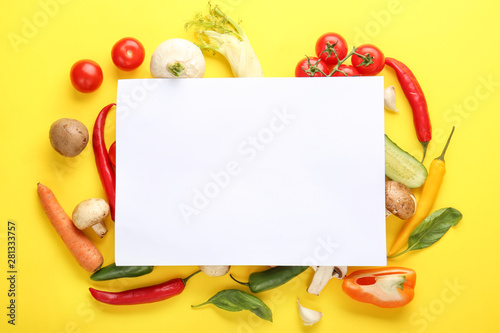 Different fresh vegetables and blank card on color background