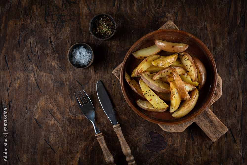 Baked potato in a plate on a wooden background, top view Baked potato in a plate on a wooden background, top view