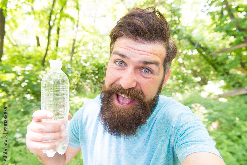 Thirst is everything. Thirsty man. Bearded man holding bottle of
