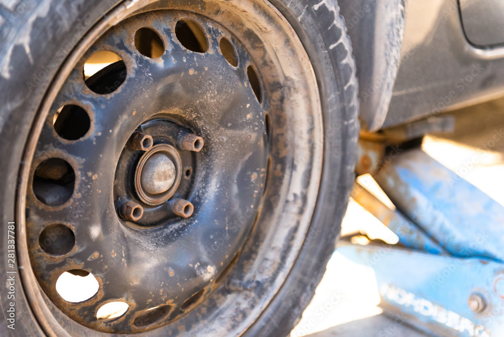 Wheel replacement. Work in tire shop. The rear wheel of the car before replacing. Wheel replacement. Work in tire shop. The rear wheel of the car before replacing.
