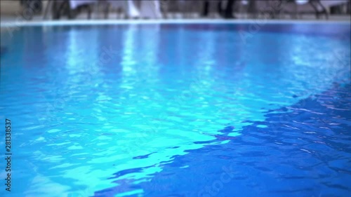 Close-up Shot Of Pool Water features a close-up shot of the clear blue waters of a swimming pool. It appears like the video was taken on a sunny day and the pool looks clean and soothing.