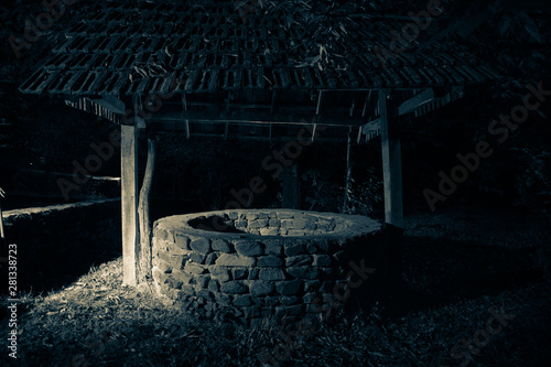 Abandoned well in the forest. Slider shot. Waiting for a terrible girl with a long hair.