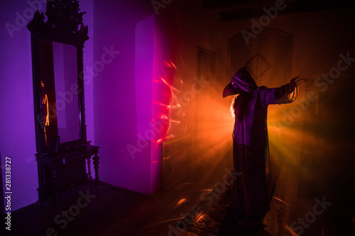 Horror silhouette of ghost inside dark room with mirror Scary halloween concept Silhouette of witch inside haunted house with fog and light on background.