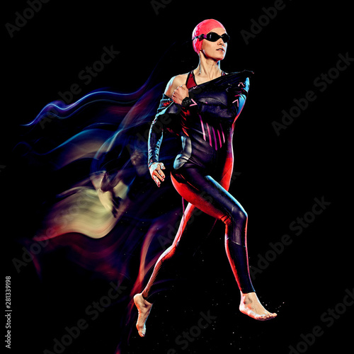 Fototapeta Naklejka Na Ścianę i Meble -  one caucasian woman triathlon triathlete studio shot isolated on black background with light painting effect