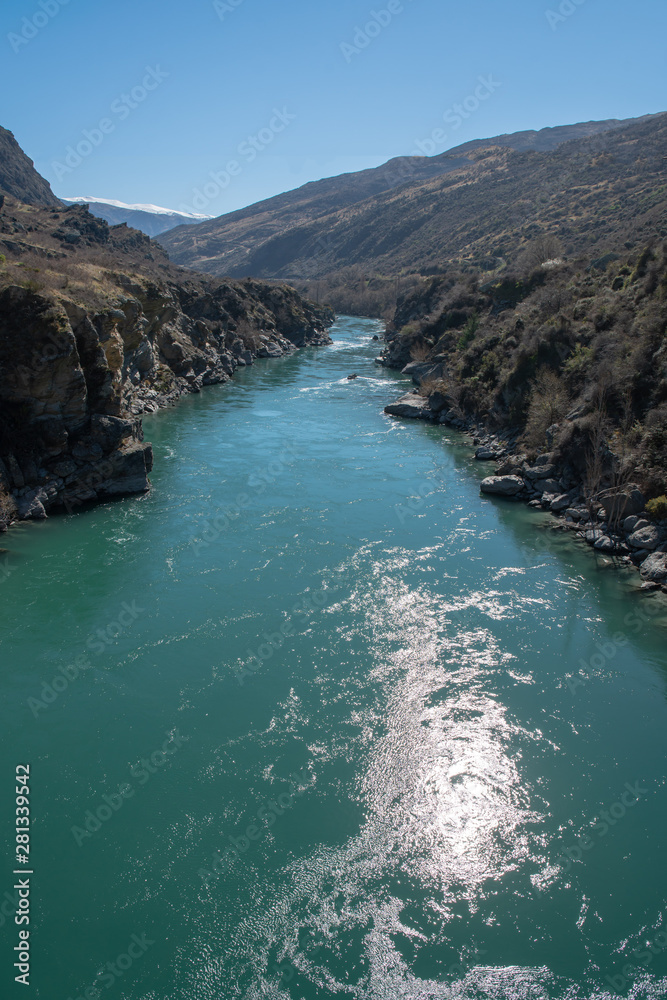 Turquoise water in the river flowing through the narrow gorge Turquoise water in the river flowing through the narrow gorge