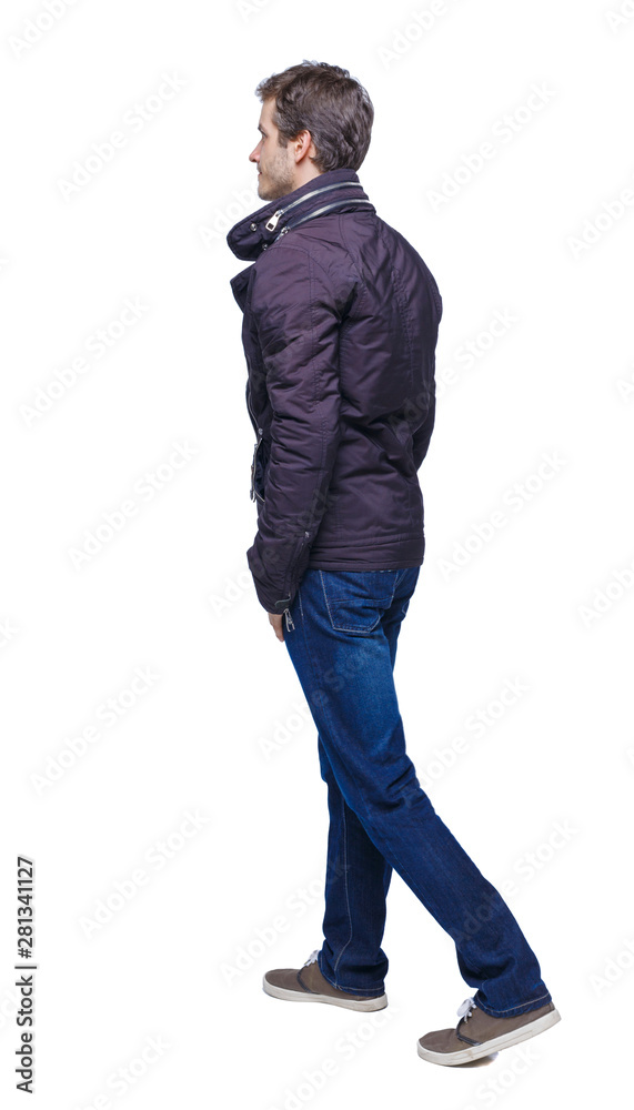 Naklejka premium Side view of going handsome man in jeans and jacket.