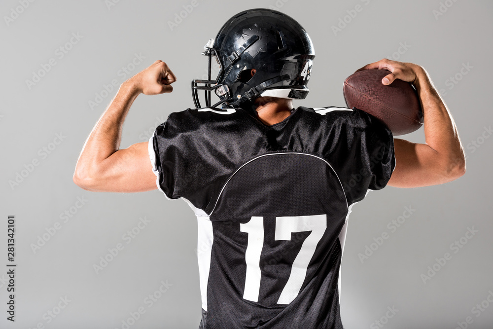 back view of American Football player with ball Isolated On grey