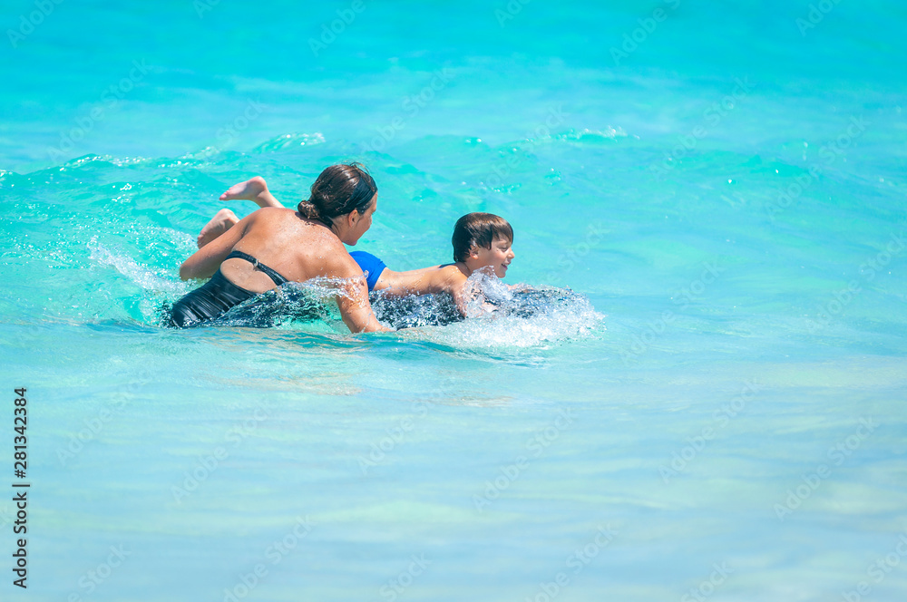 Loving mom teaches young boy to bodysurf Loving mom teaches young boy to bodysurf