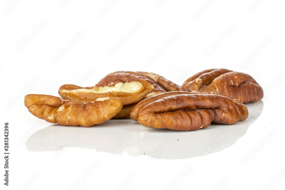 Group of three whole two halves of fresh brown pecan nut half isolated on white background