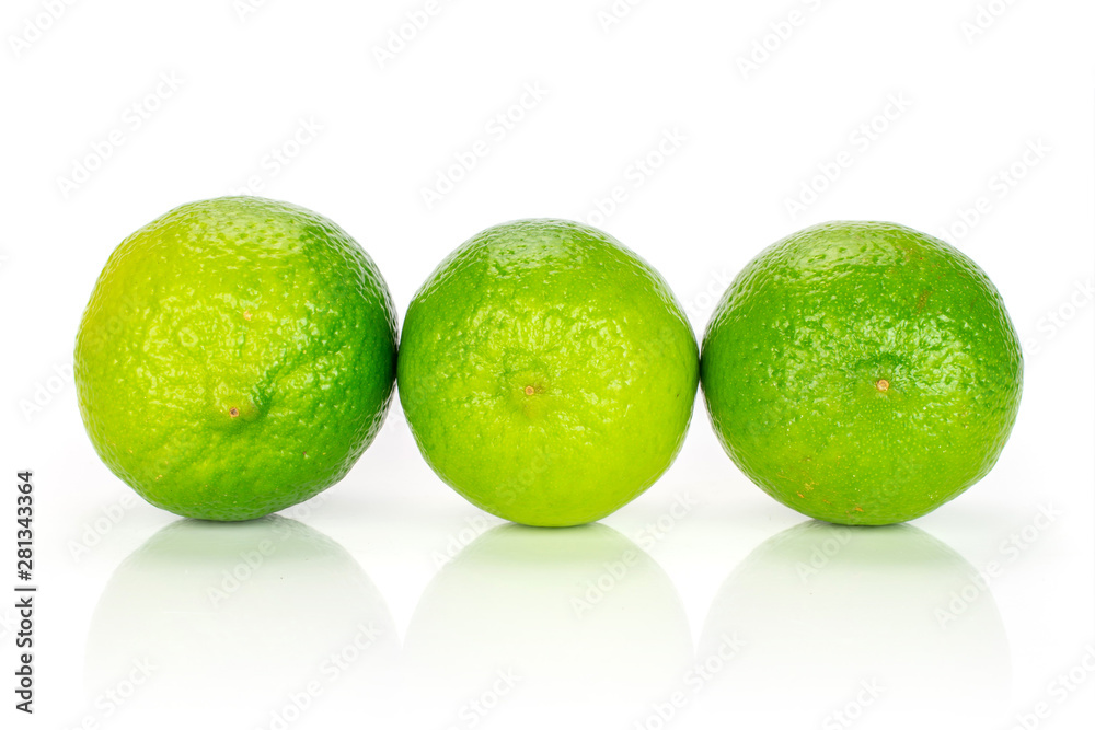 Group of three whole fresh green lime placed in a row isolated on white background Group of three whole fresh green lime placed in a row isolated on white background