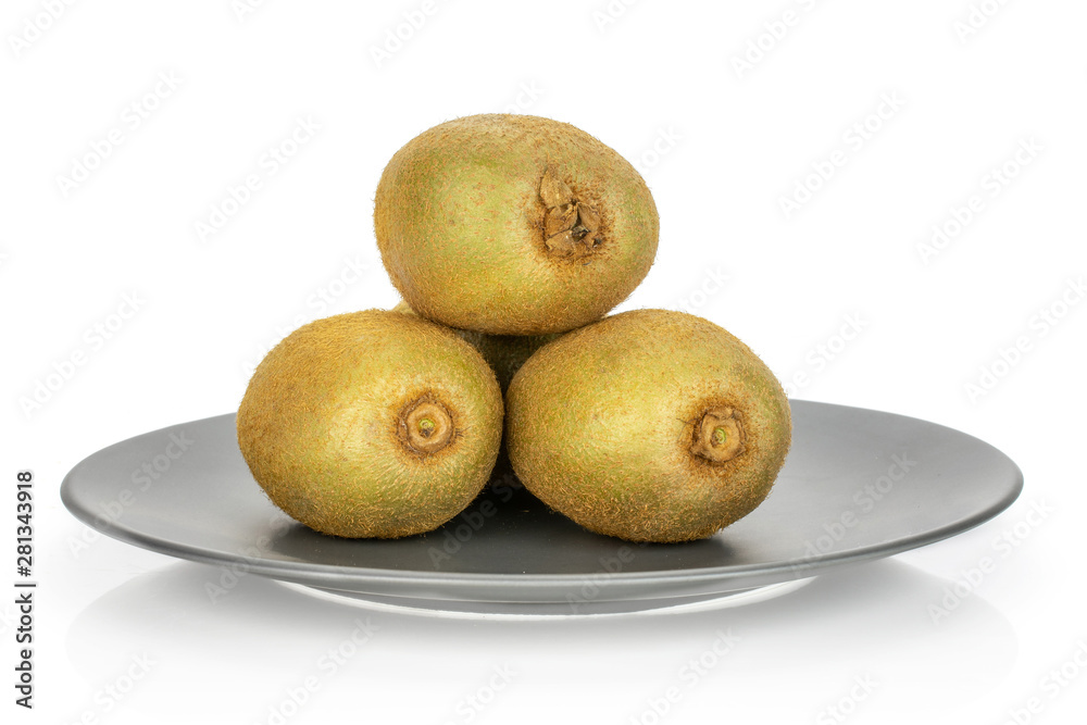 Fototapeta premium Group of three whole fresh green kiwifruit actinidia deliciosa one is on the top of the others on a gray ceramic plate isolated on white background