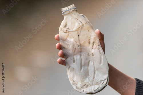 A teenagger grabbing plastic garbage. photo