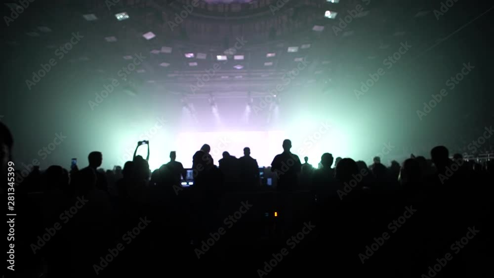Band performance in a concert hall crowded with people