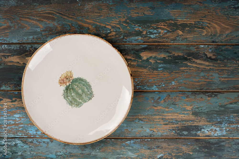 Empty plate with fork and knife on colored wooden background, top view, copy space, mock-up