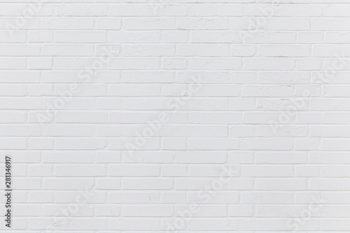 Simple white brick wall with light gray shades seamless pattern surface texture wide format background.
