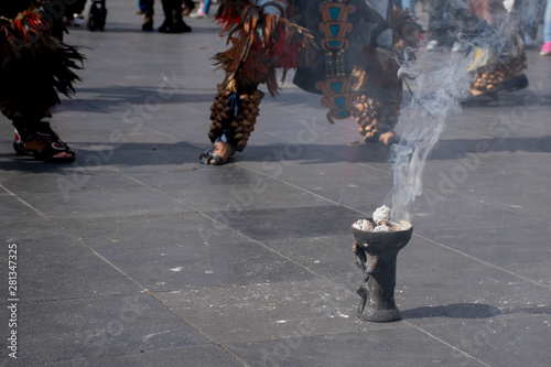 Pies de danzante mexicano con huaraches típicos y ornamentos llamados huesos de fraile, acompañados de copal photo